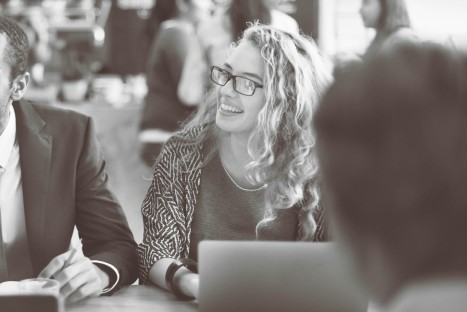 Students collaborating on investment analysis projects in modern learning environment